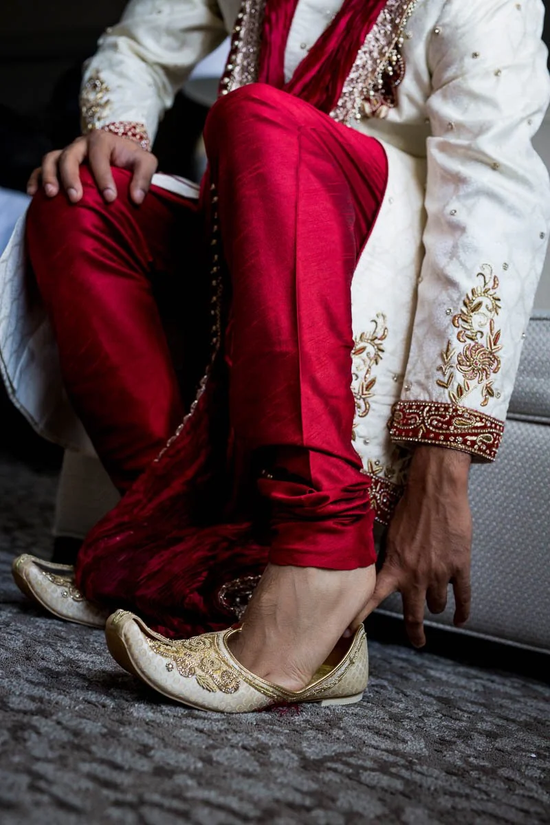  Groom putting on shoes at Ritz-Carlton Indian Wedding 