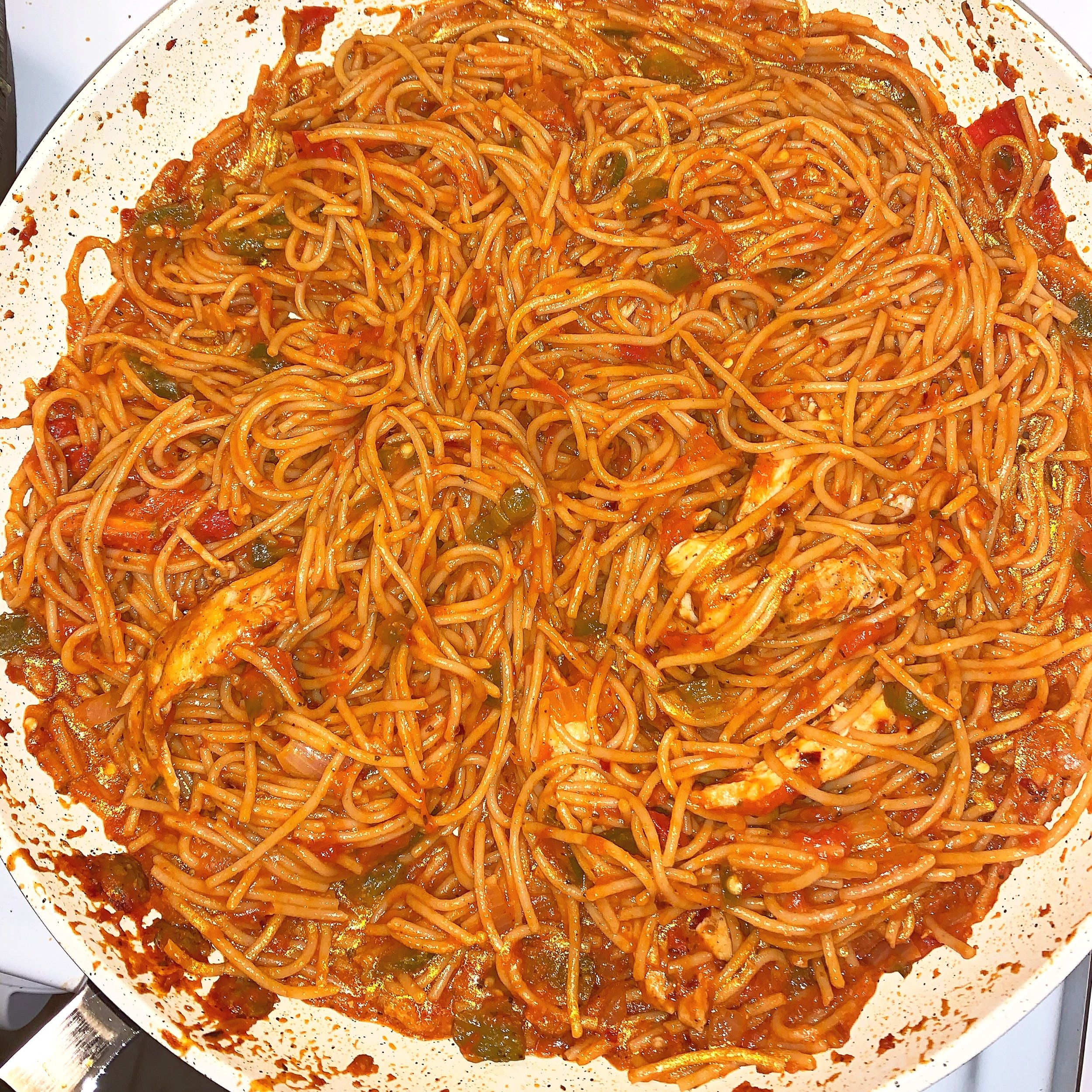 Spicy Indian/Italian spiced tomato sauce, sautéed veggies and grilled chicken with spaghetti