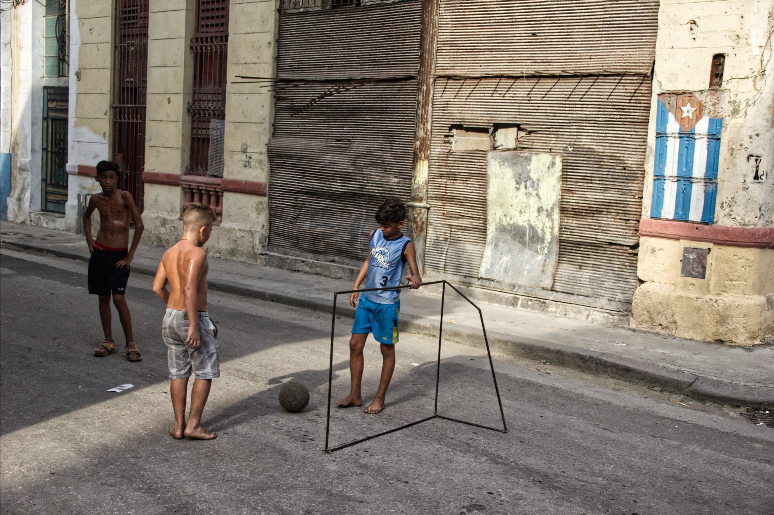 Kids playing soccer on one street in Central Havana, notice that two of them have no shoes.| Credit: Reynaldo Cruz Diaz