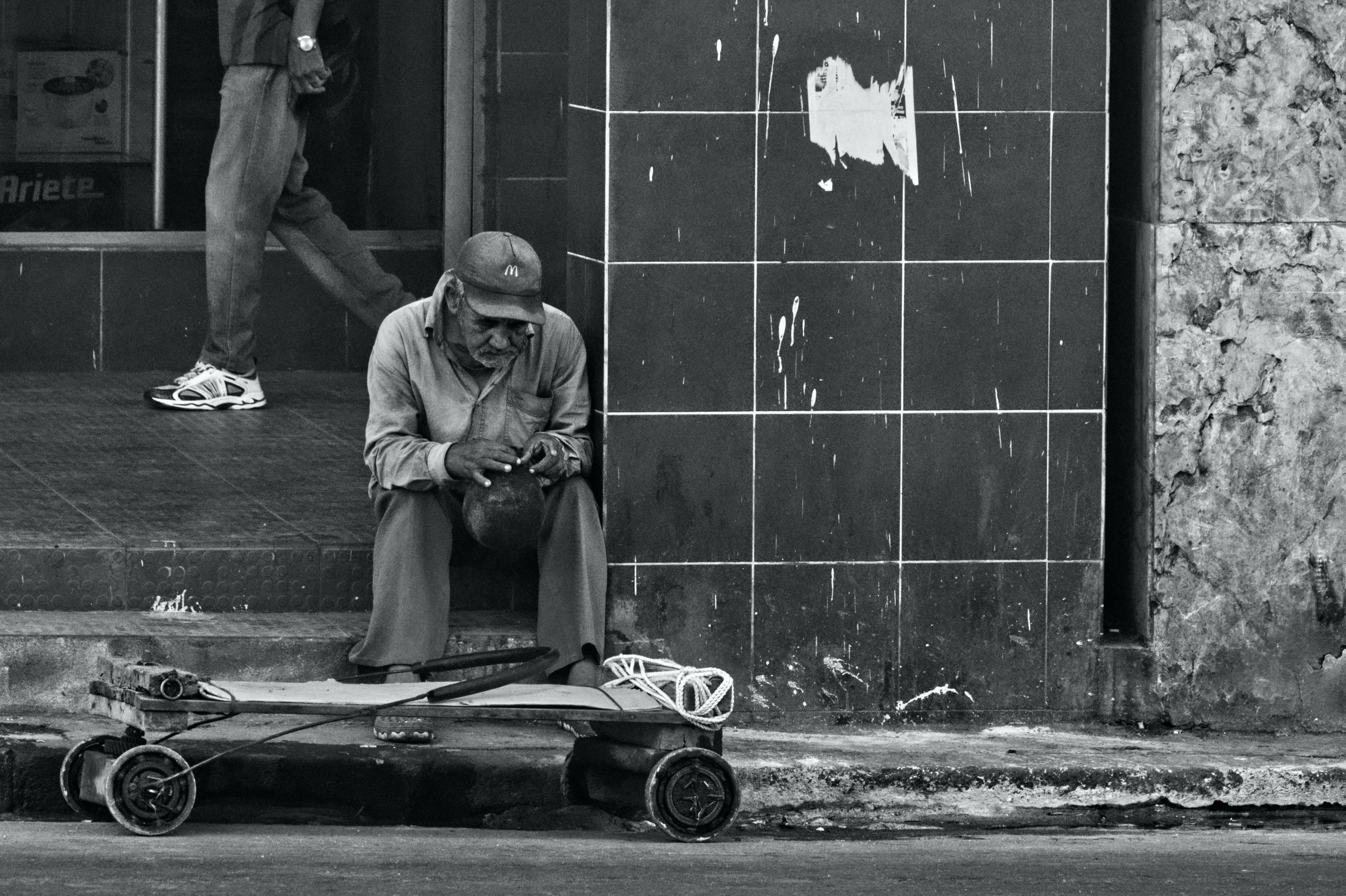 An old man sits with a little cart on Calle Reina in Central Havana. Despair, sadness and hopelessness are evident in him.| Credit: Reynaldo Cruz Diaz