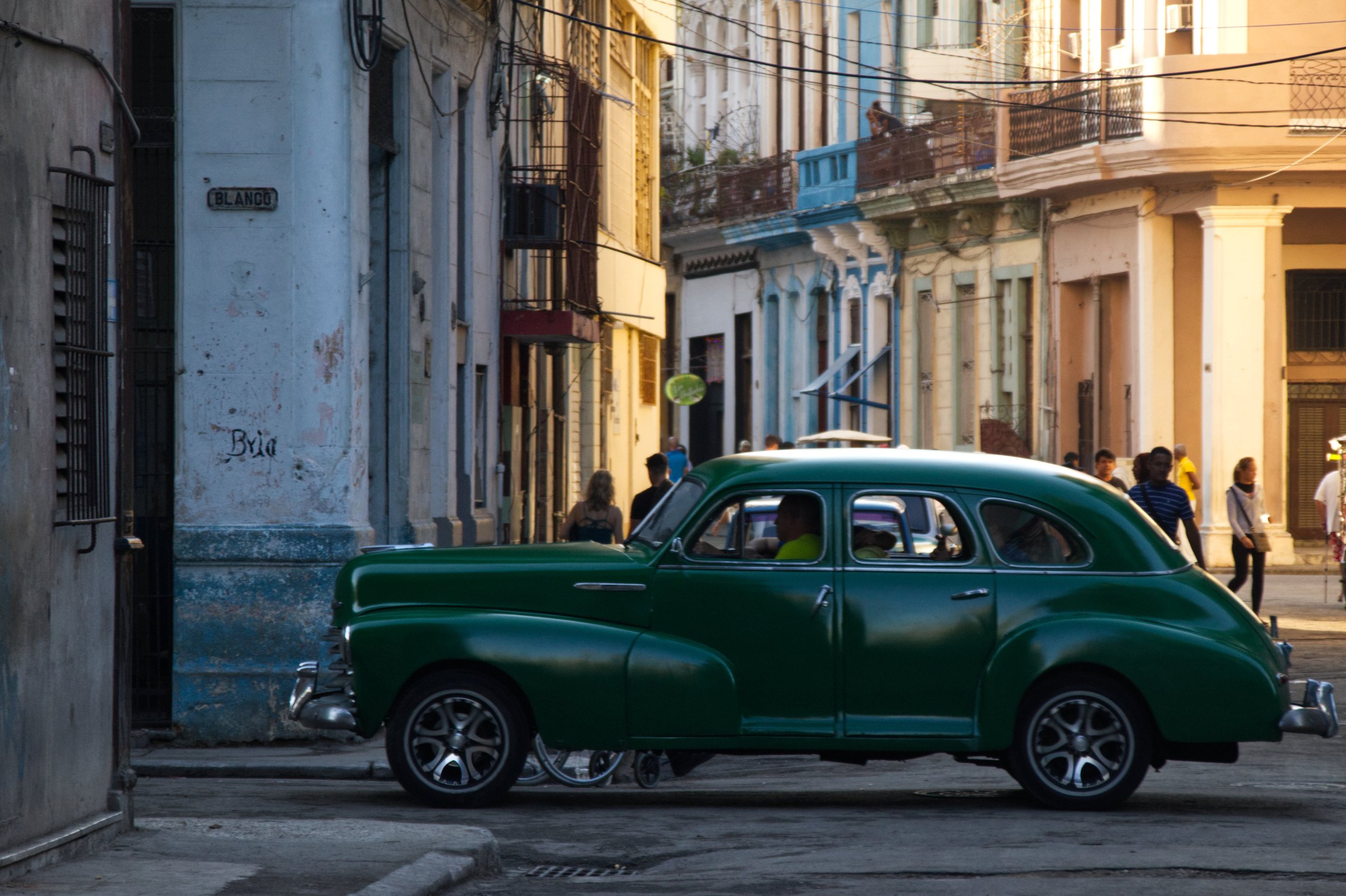 An old car drives along a street in Central Havana.| Credit: Reynaldo Cruz Diaz