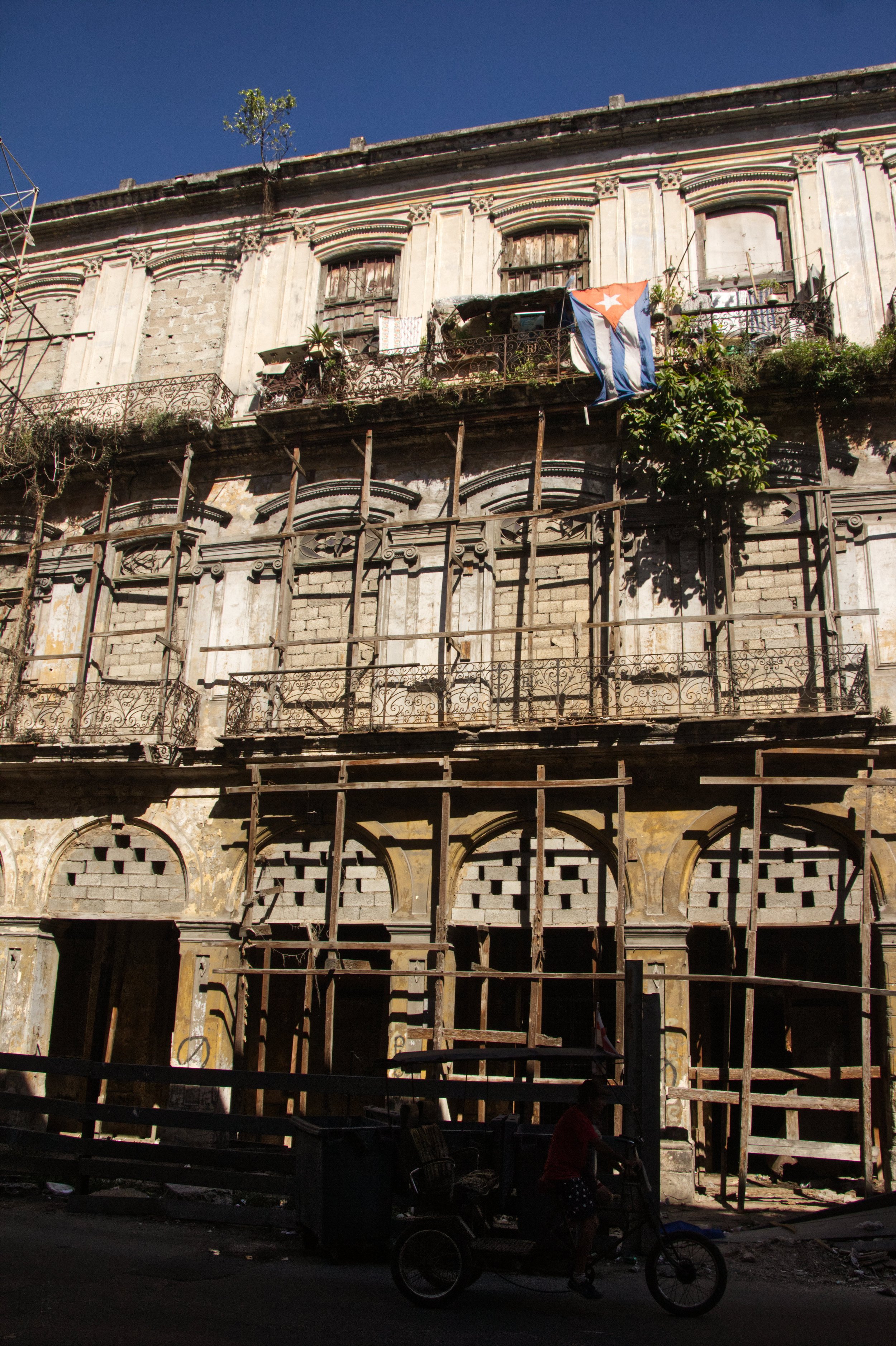 A condemned building has one inhabitant in one of the high floors. The person hangs a Cuban flag there, and still supports the Castro regime.| Credit: Reynaldo Cruz Diaz