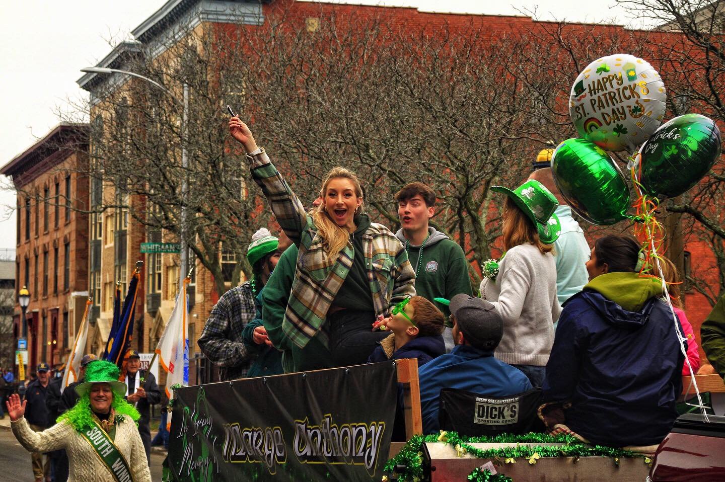 A woman on top of a float waves at me during the 2022 St. Patrick’s Day parade in Hartford.| Credit: Reynaldo Cruz Diaz