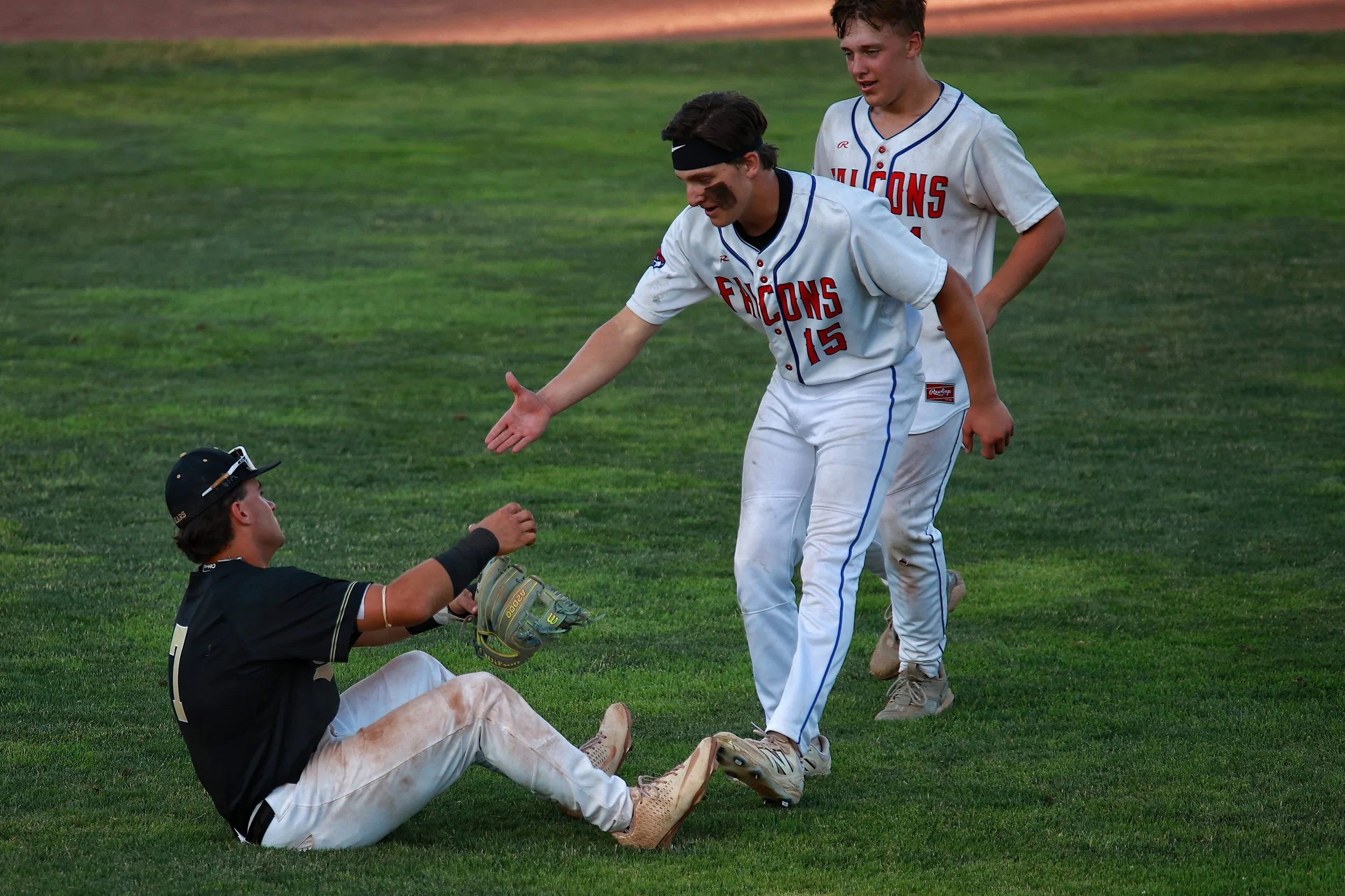  St. Paul Falcons Jack McDougall (#15) and Evan Judenis come to show respect to the opposing third baseman of the Stonington Bears after winning the Class S Connecticut State Championship.| Credit: Reynaldo Cruz Diaz  