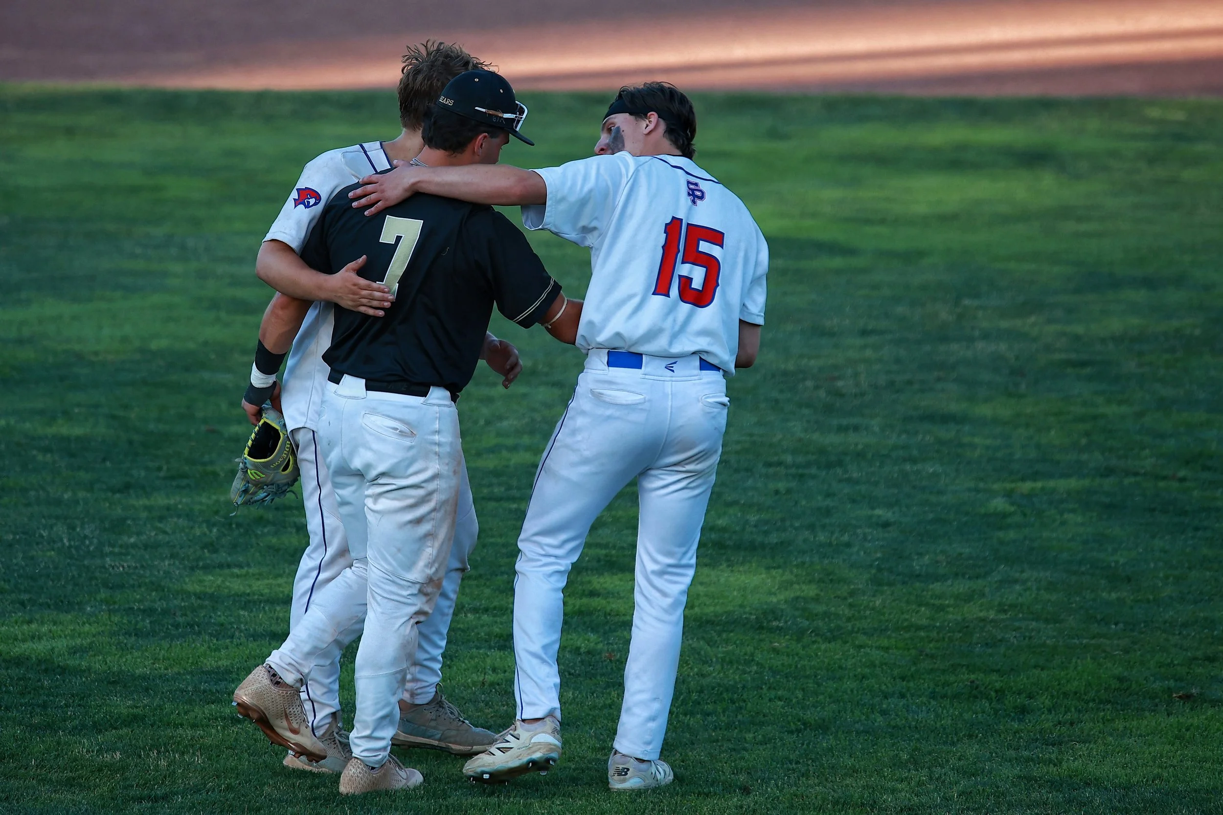  St. Paul Falcons Jack McDougall (#15) and Evan Judenis come to show respect to the opposing third baseman of the Stonington Bears after winning the Class S Connecticut State Championship.| Credit: Reynaldo Cruz Diaz  