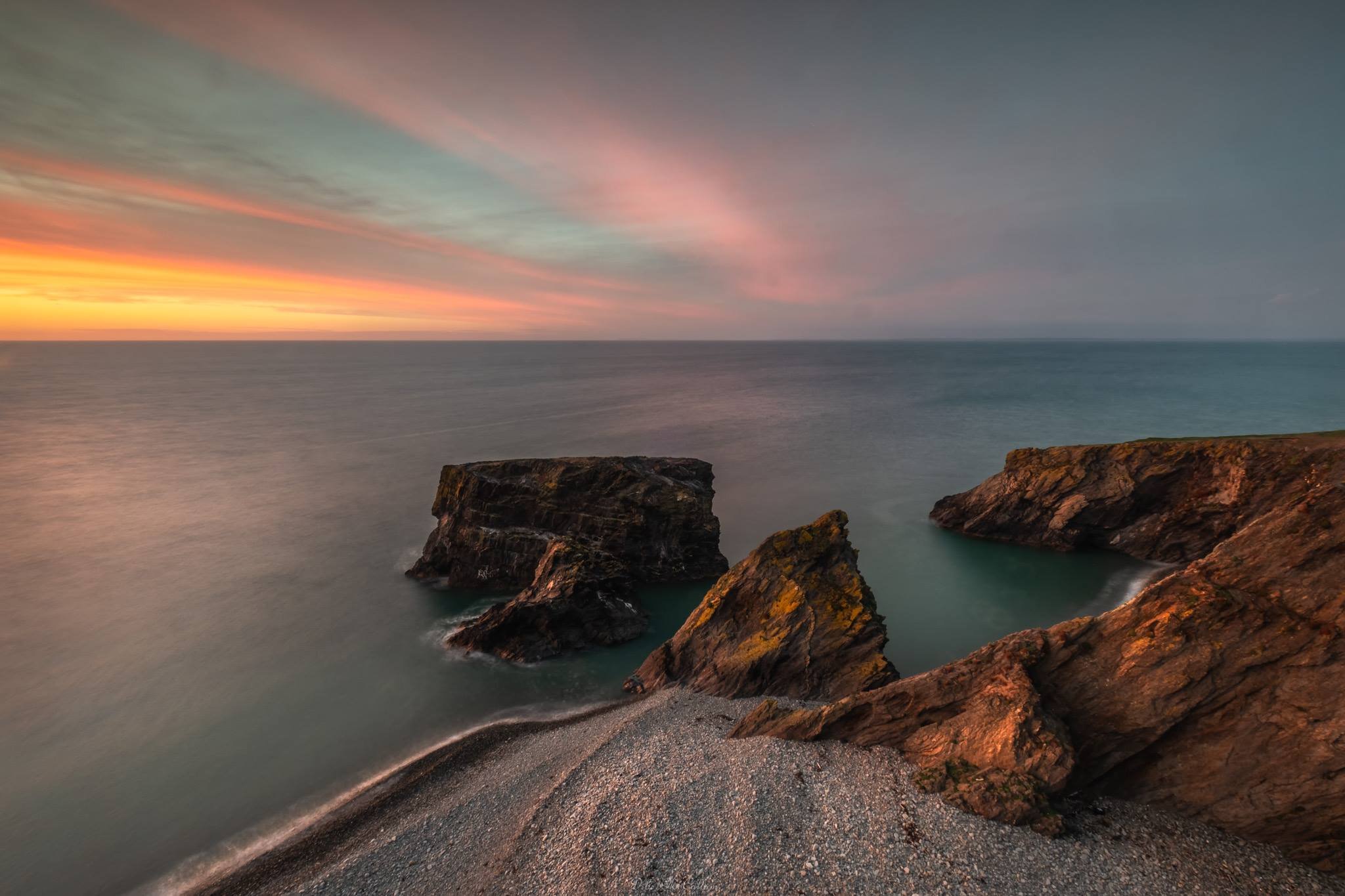 A breathtaking sunset over the cliffs at Trefor, casting a warm glow on the rugged coastline. (Copy)