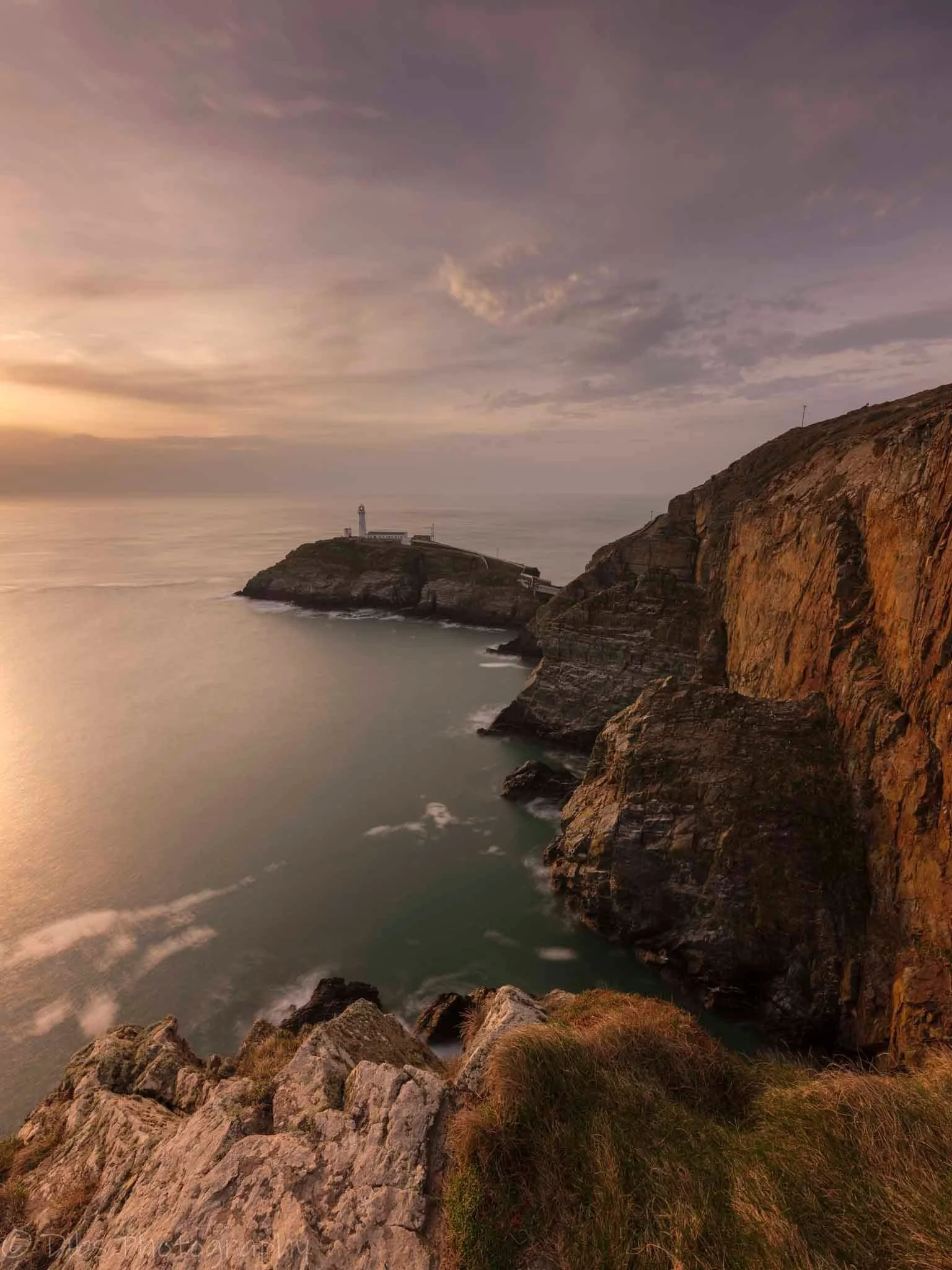 South Stack Lighthouse below the Anglesey cliffs at dusk