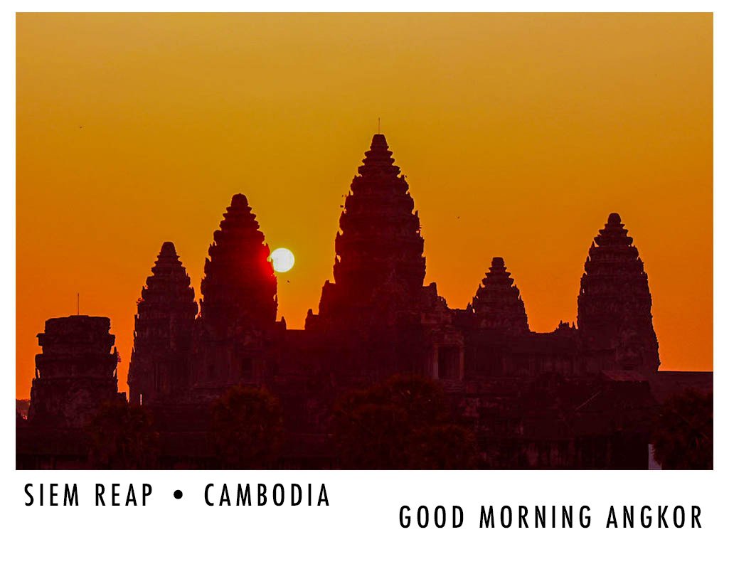Silhouetted Angkor Wat temples during sunrise with the sun rising behind the main tower, orange sky in Cambodia, with text 'SIEM REAP CAMBODIA GOOD MORNING ANGKOR' at the bottom.