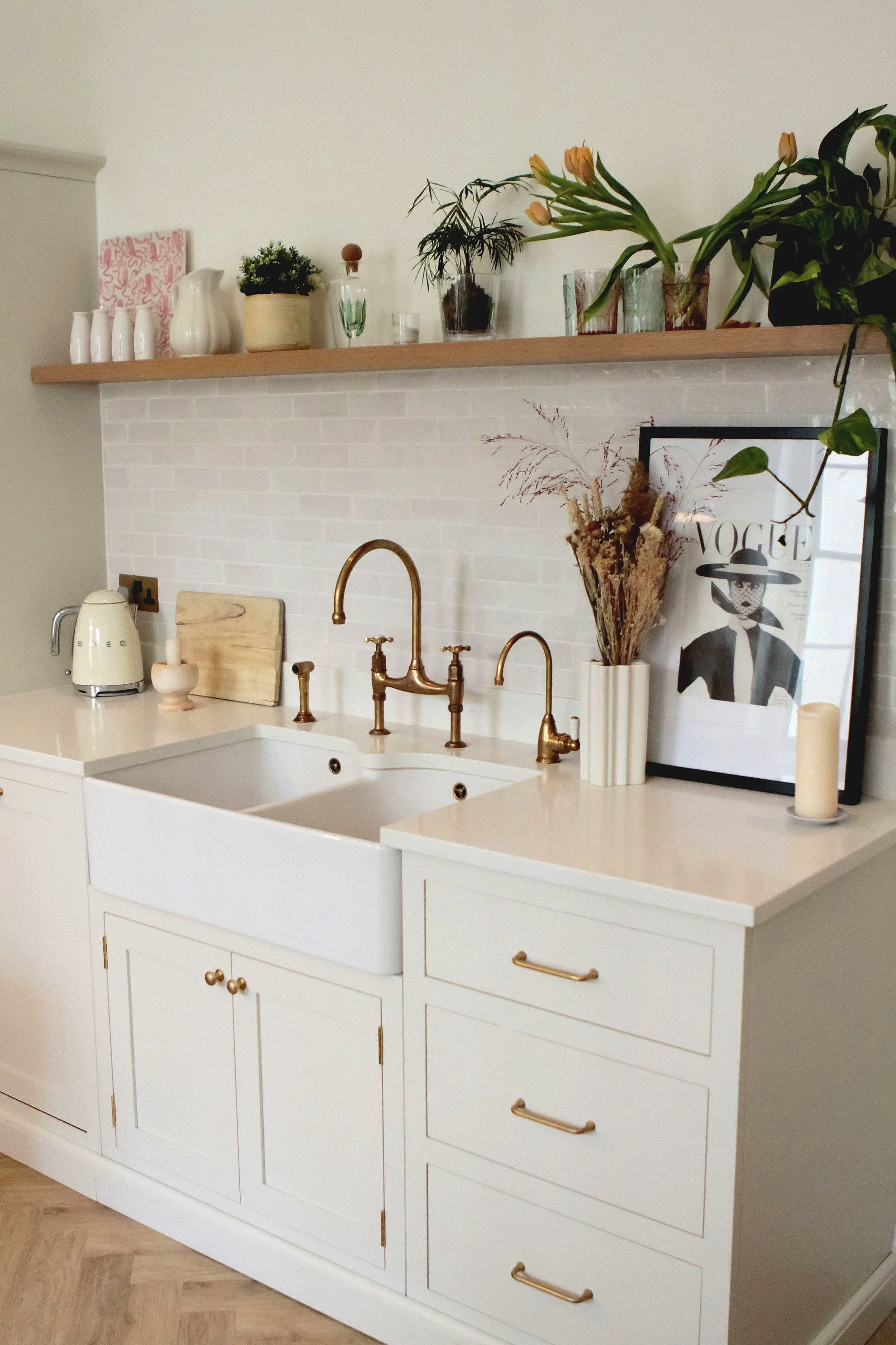 Painted hardwood cabinets in off-white with brass hardware