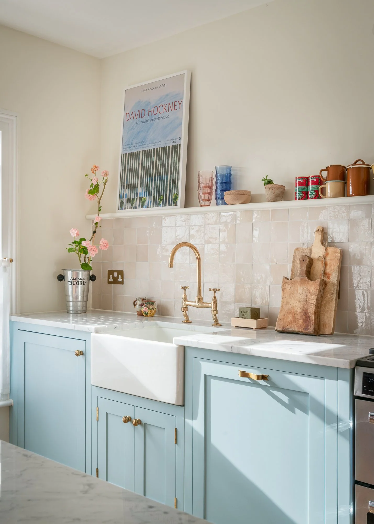 Natural marble kitchen worktop with soft veining and tiled splashback