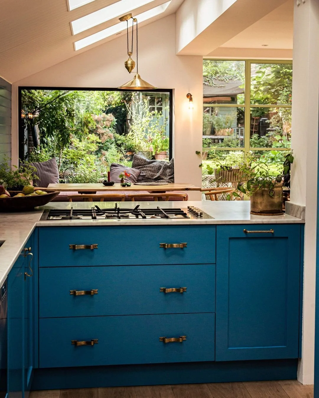 This kitchen has so much personality - bold blue cabinetry, which looks so beautiful against the green garden backdrop. Wonderful use of colour in a garden flat. 
#BoldDesign #FallowWorkshops #KitchenInspo #Askew