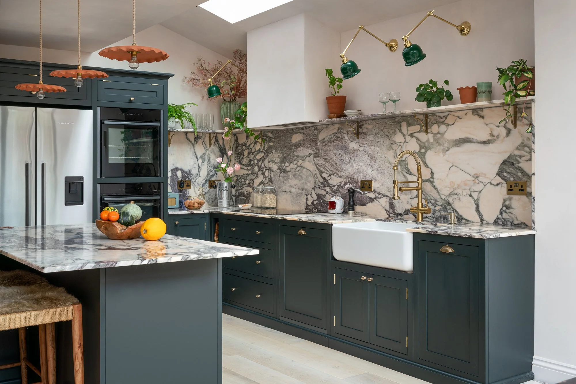 Large kitchen island with integrated seating and veined marble worktop
