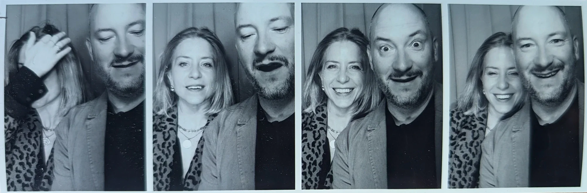 Photo booth strip of a man and woman making various facial expressions and poses, in black and white.