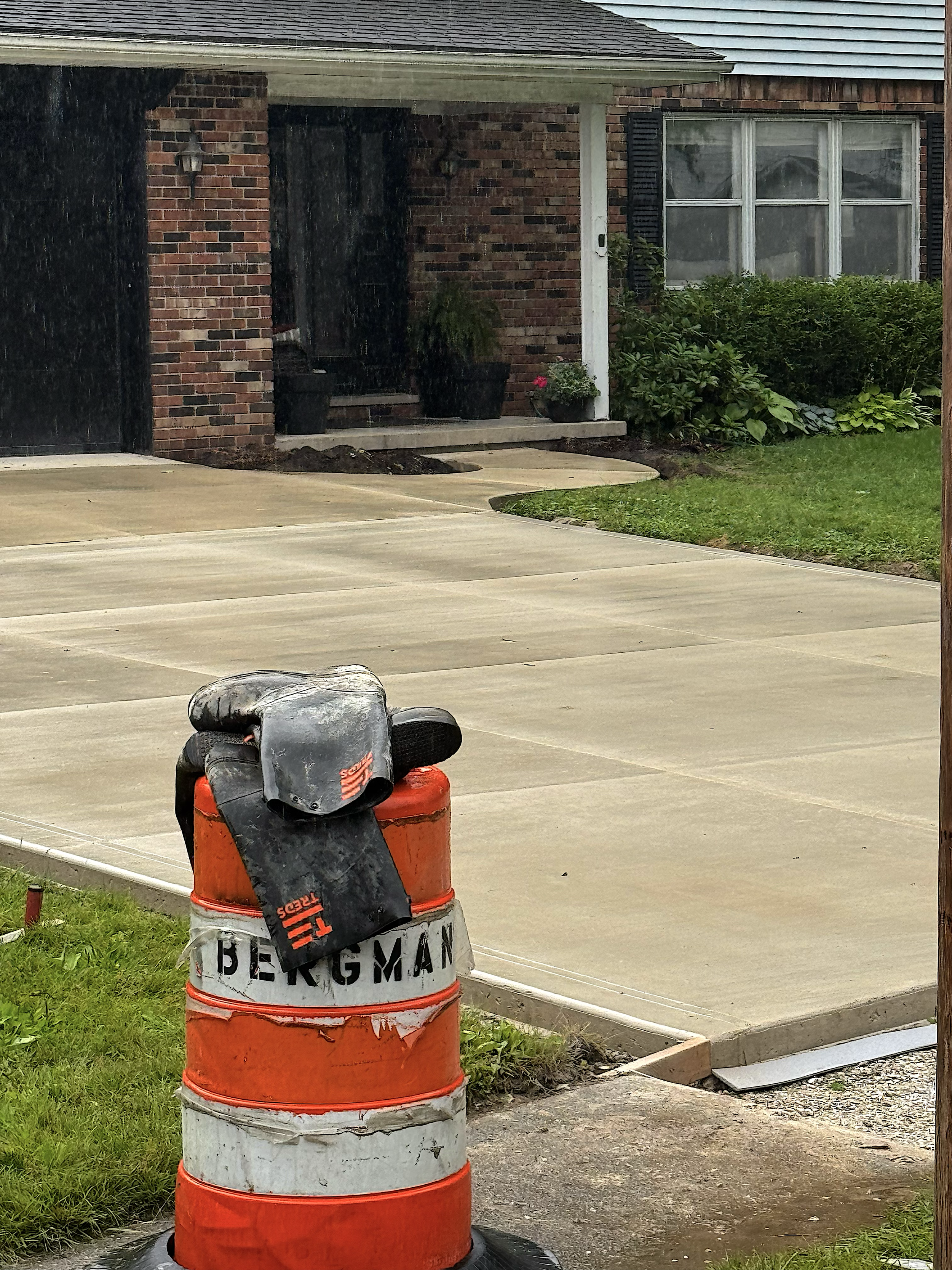 Concrete Boots on top of a Bergman Concrete Barrel with a new driveway being completed in the background