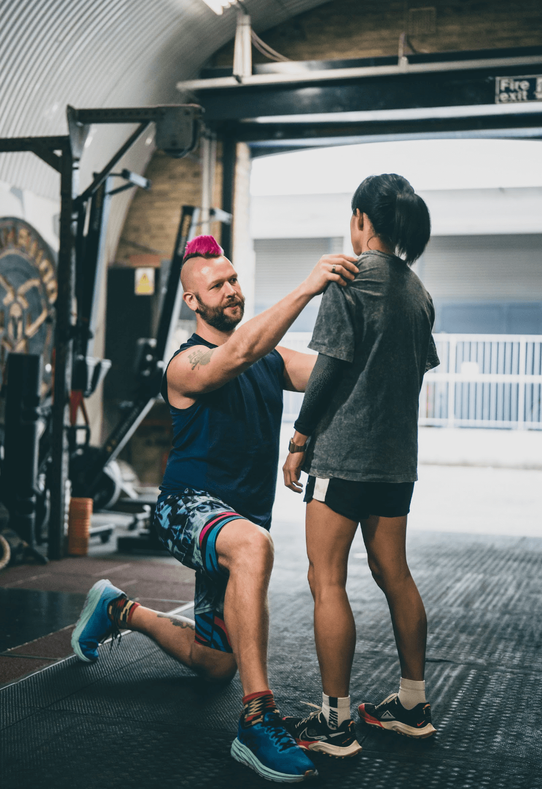 body reading by guy with mohawk on Korean woman. Assessment of lateral lines of the torso. Fascia work London UK