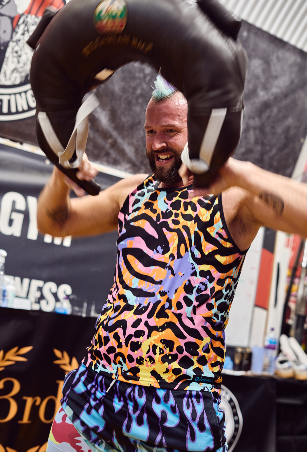 man with mohawk performs snatch with Bulgarian bags in London gym