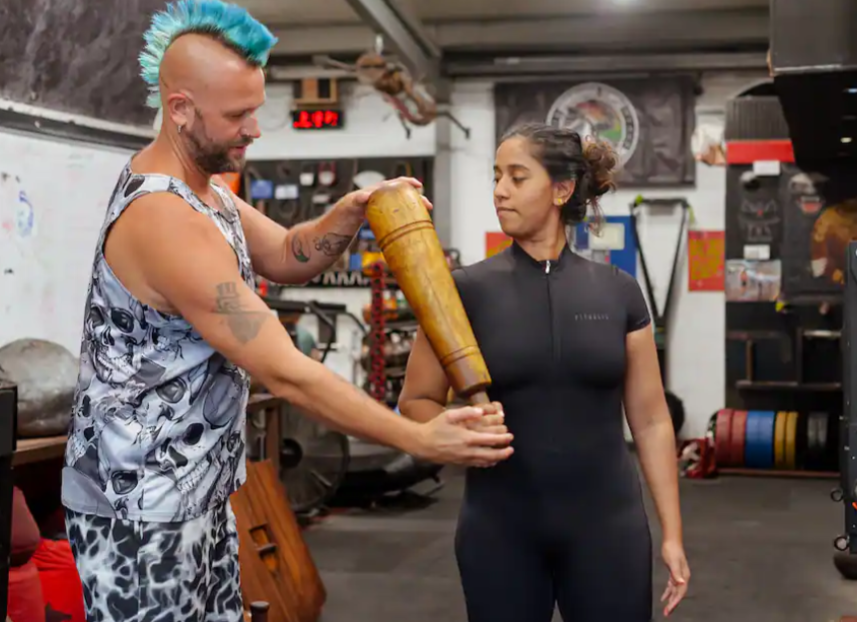 man with mohawk helping a woman learn how to use Persian meels in London