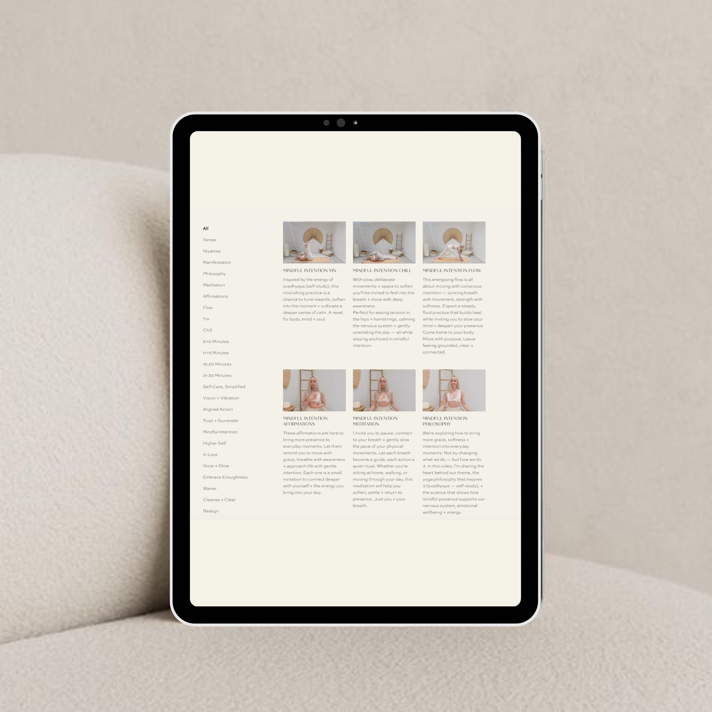 A digital tablet displays a webpage with text and images related to mindfulness and meditation, placed on a beige couch.