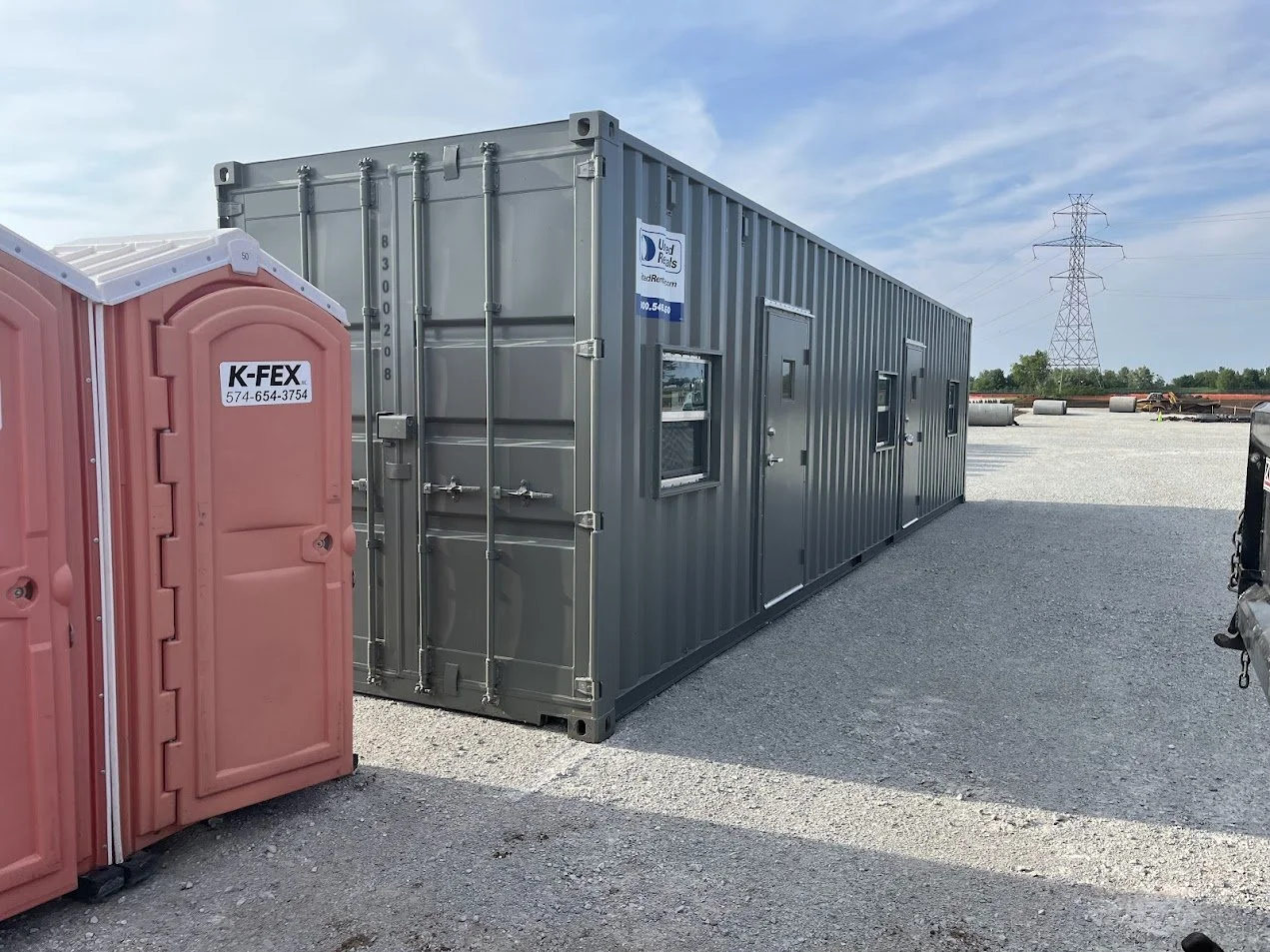Two K-FEX portable toilets in a large construction site