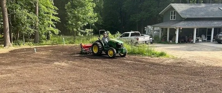 A K-FEX tractor tilling and clearing a lawn in Laporte