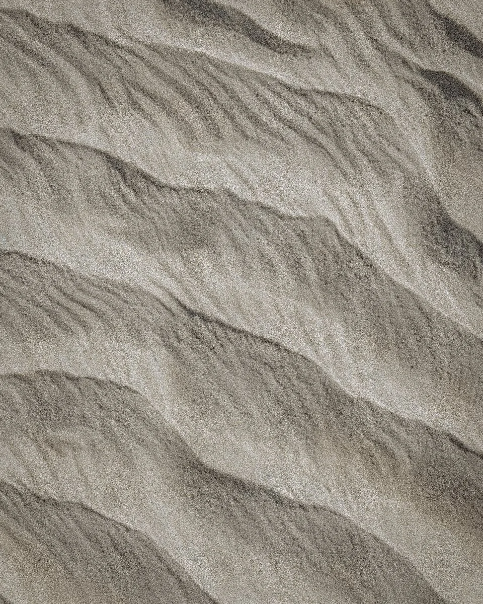 Close-up of textured fabric with wavy lines and intricate stitching.
