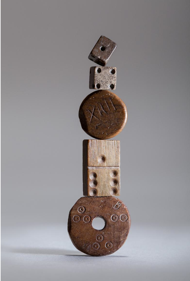 Hand-carved Bone Gaming Pieces
The dice and domino are c. 17th Century. The 'XIII' piece is Roman, AD 100-300. The piece with three sets of dots is medieval. Photo: Hannah Smiles