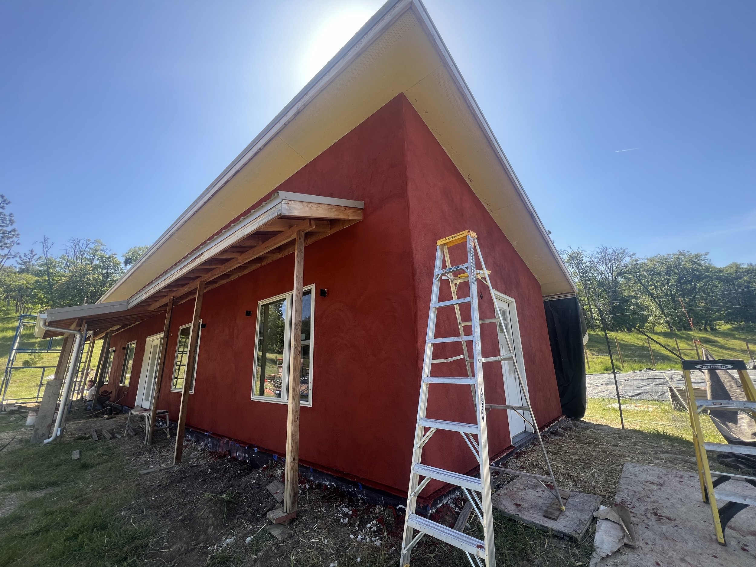 red straw bale exterior lime plaster.jpg