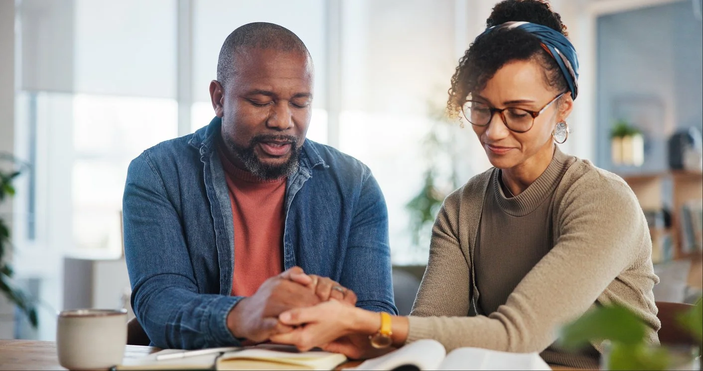 Christian couple praying together at a marriage retreat.