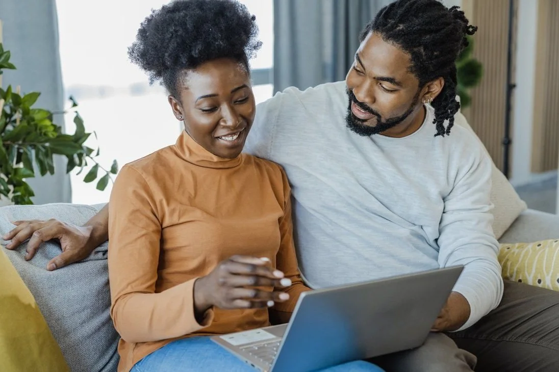 Couple with laptop watching the Renovation Marriage online marriage course, which helps couples in crisis break out of roommate syndrome and improve communication.