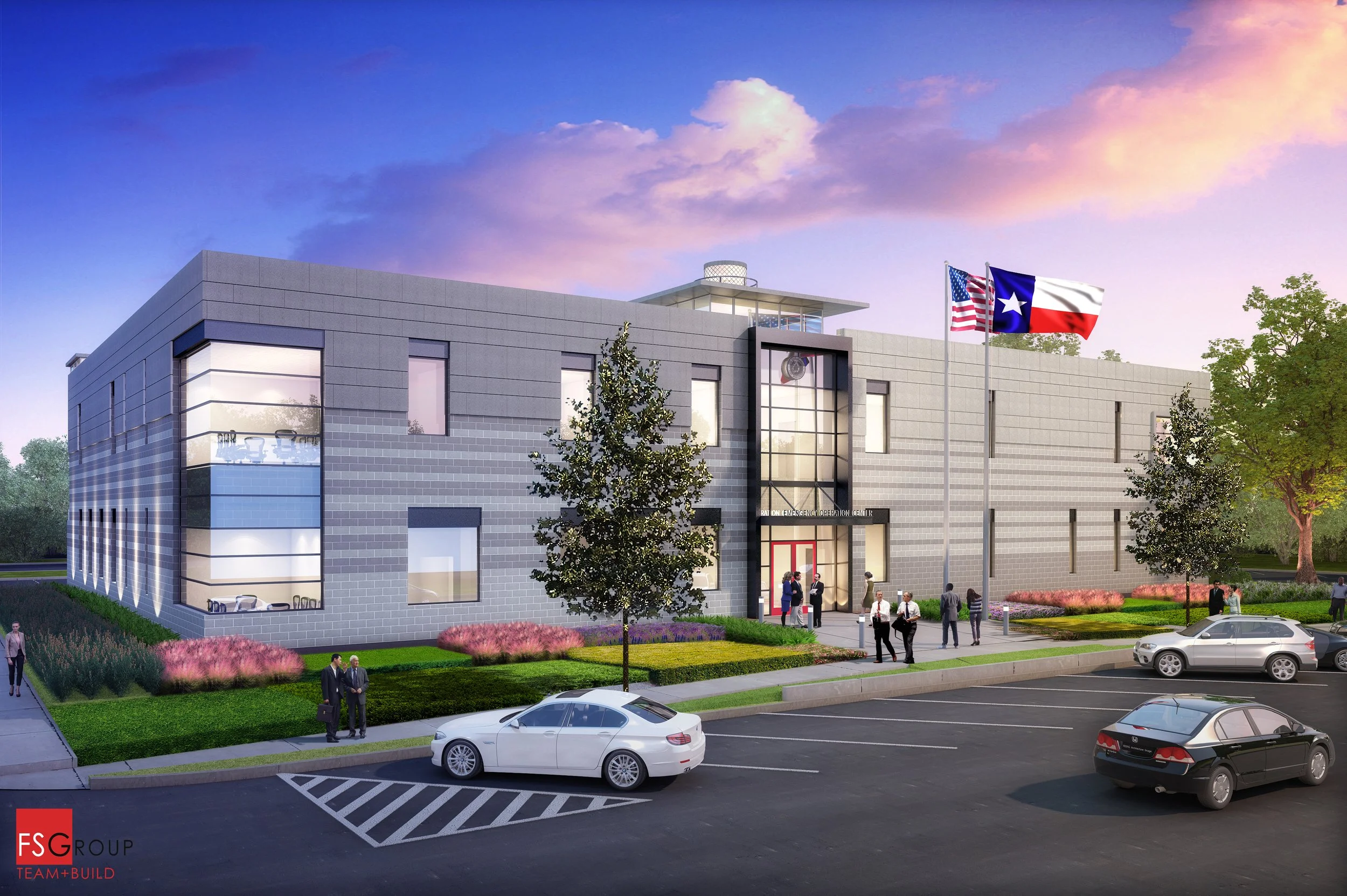 A modern two-story emergency operations center building with parking lot and landscaped front yard. Flagpoles display the American and Texas flags in front of the building. People are walking and standing outside the entrance.