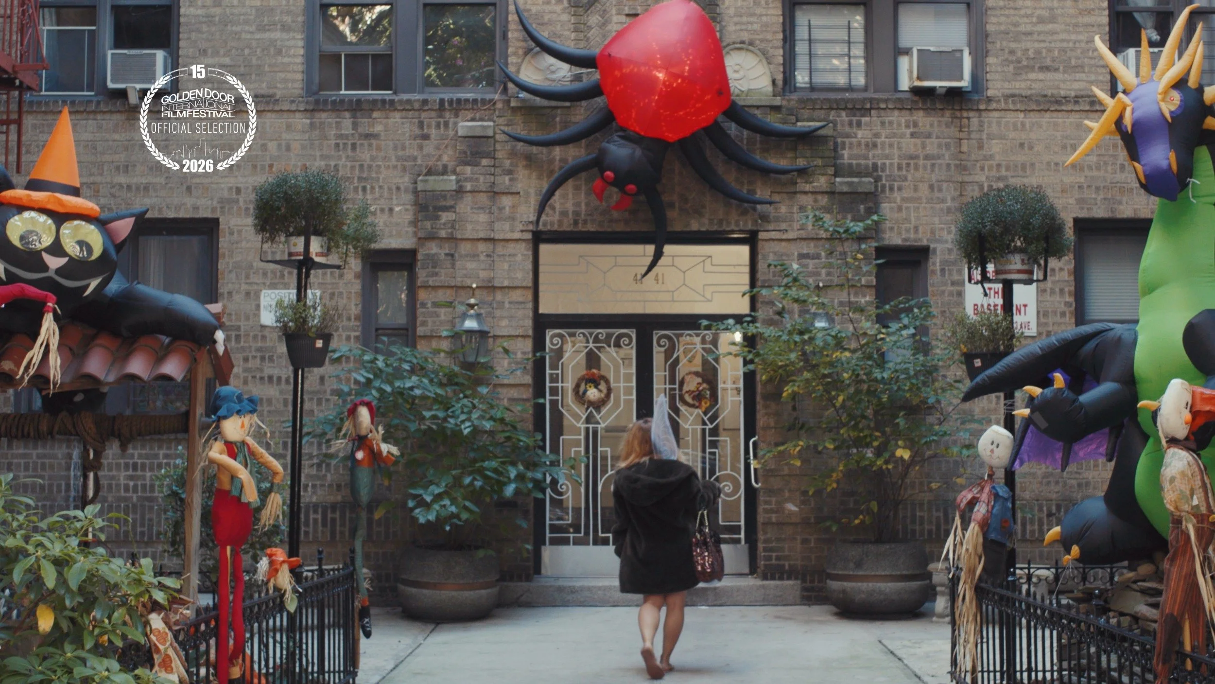 Woman walking into apartment building decorated for Halloween. Still from short film Fairy Tale, GDIFF Official Selection 2026