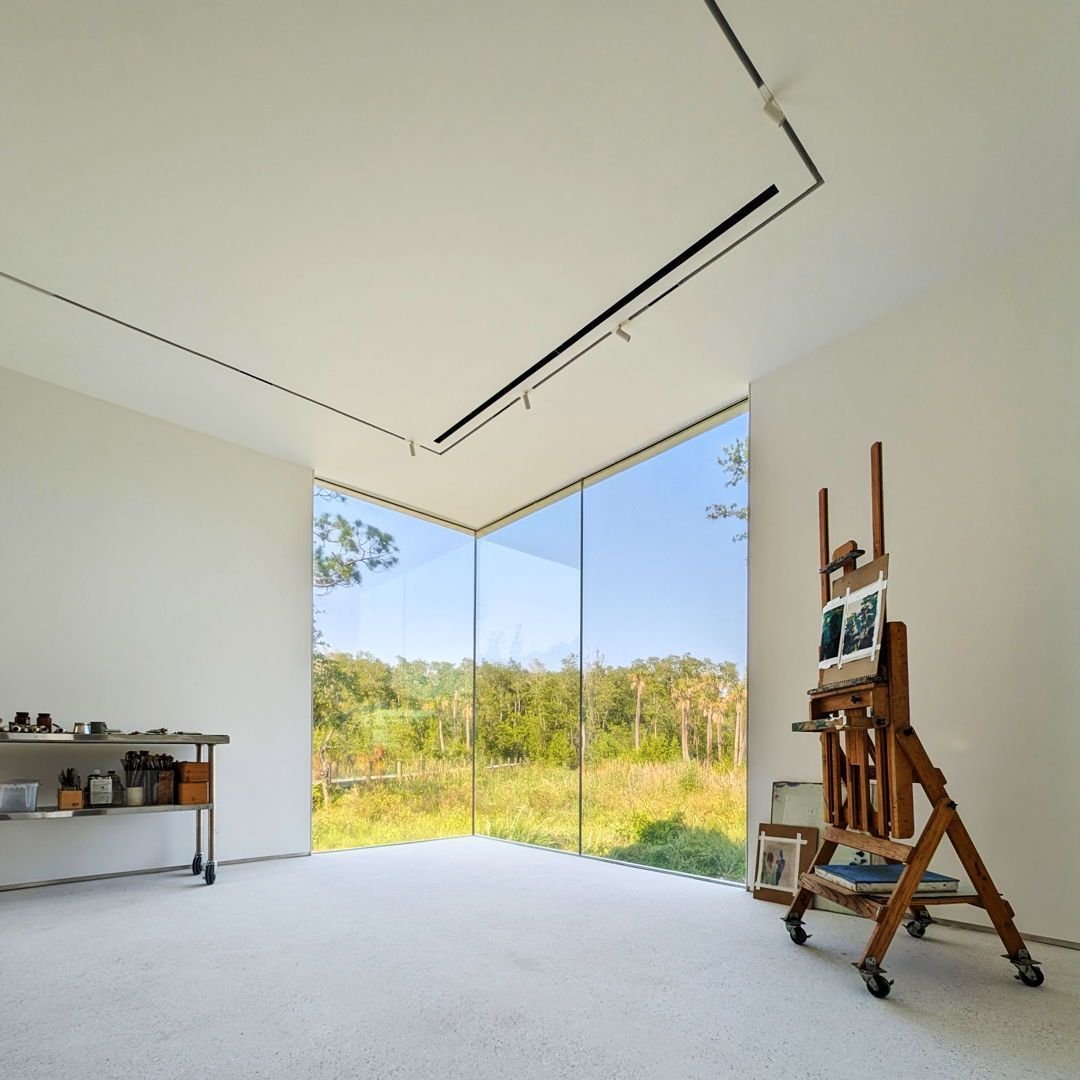 NAA designed this studio for an artist that draws deep inspiration from the landscape.  The main studio was considered as an open area with ample space for creating and displaying artwork, flexible recessed track lighting, and a corner glass wall wit