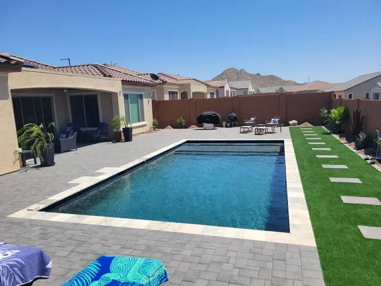 Backyard with a swimming pool, paved patio, outdoor furniture, grill, and mountain view.