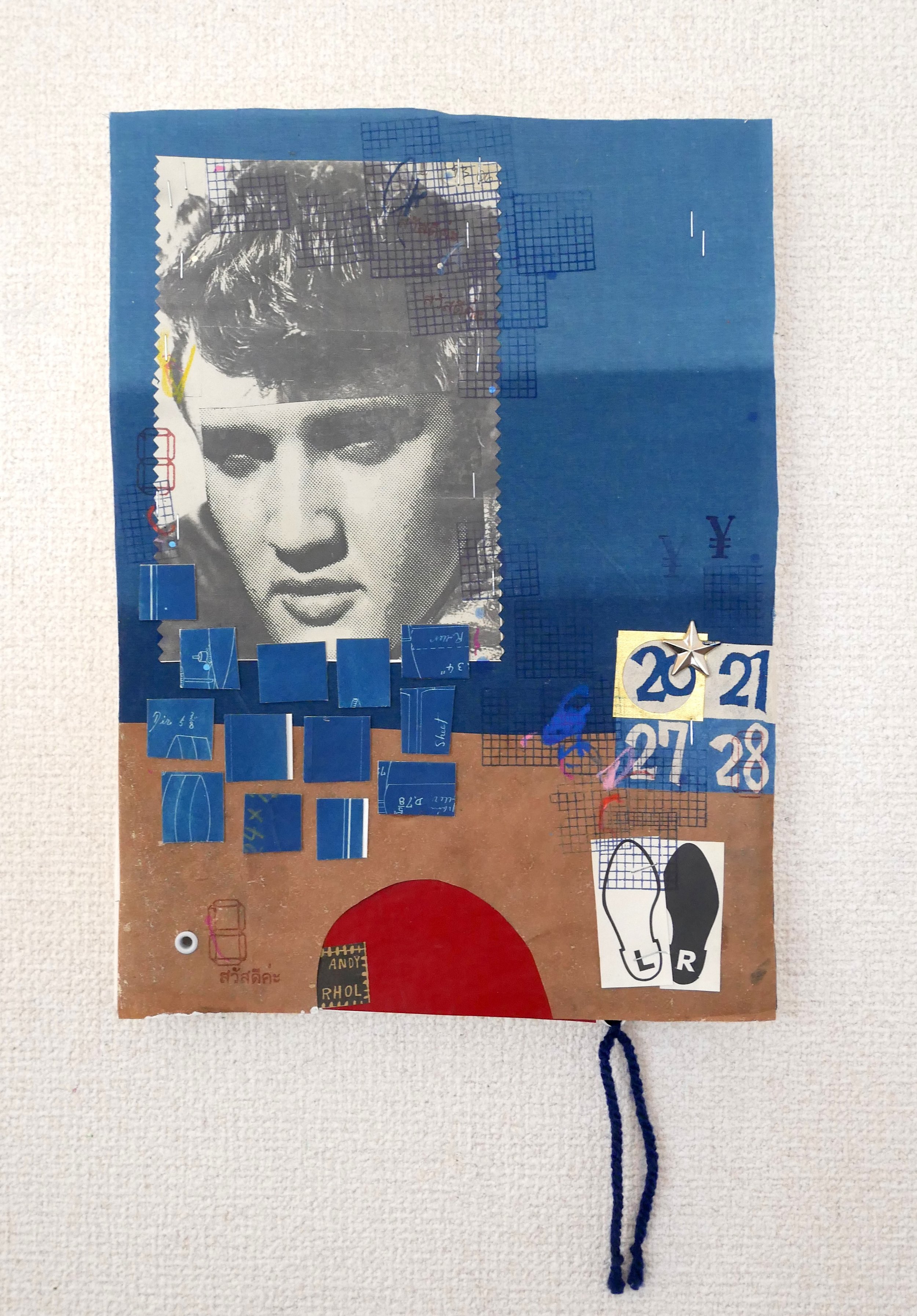 ELVIS 20, 2026. Vintage Japanese dyed papers, indigo-dyed cotton, ink, metal and string on thick handmade paper.  Mounted on wood panel. 23x42x2.5cm / $200.00