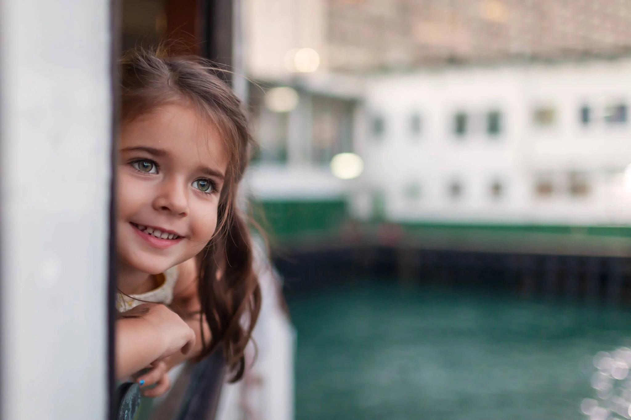 Girl gazing out the Star Ferry window in Hong Kong