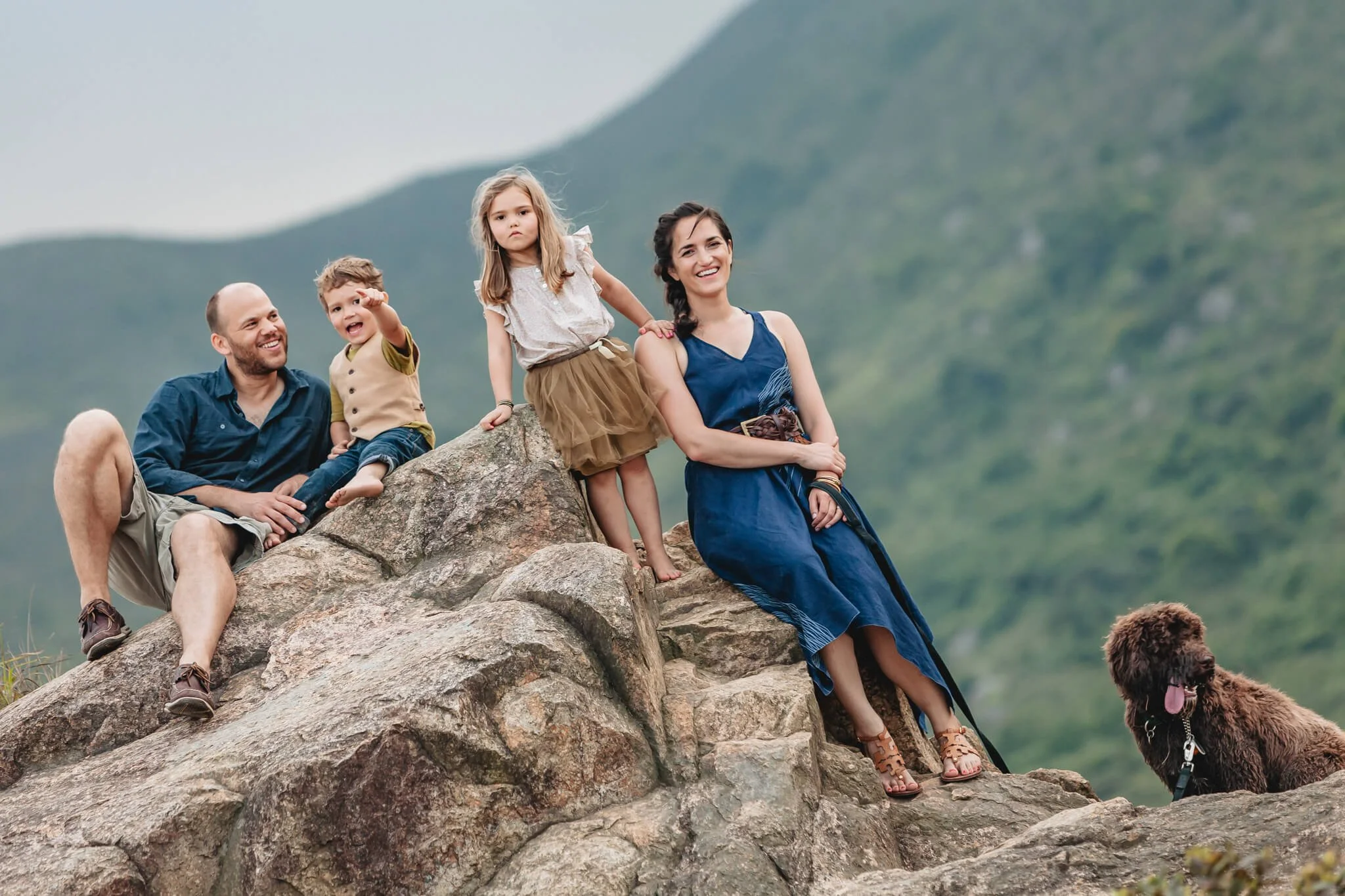 Family on a hill behind Discovery Bay on a family photoshoot, with the dog