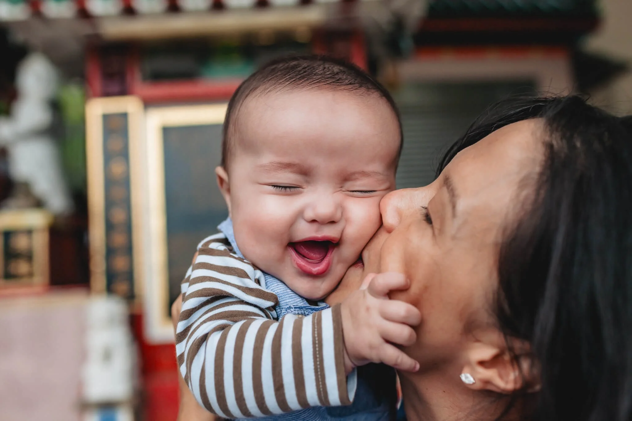 Mom kisses toddler at Repulse Bay Beach