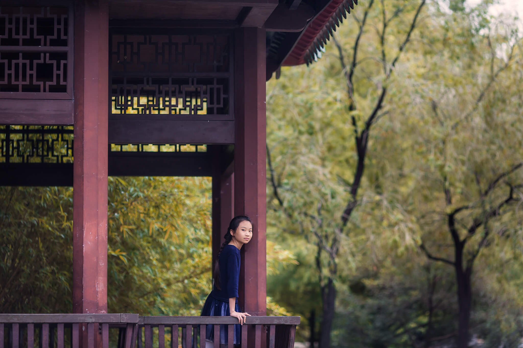 Girl standing in Chinese building in Lingnan Garden