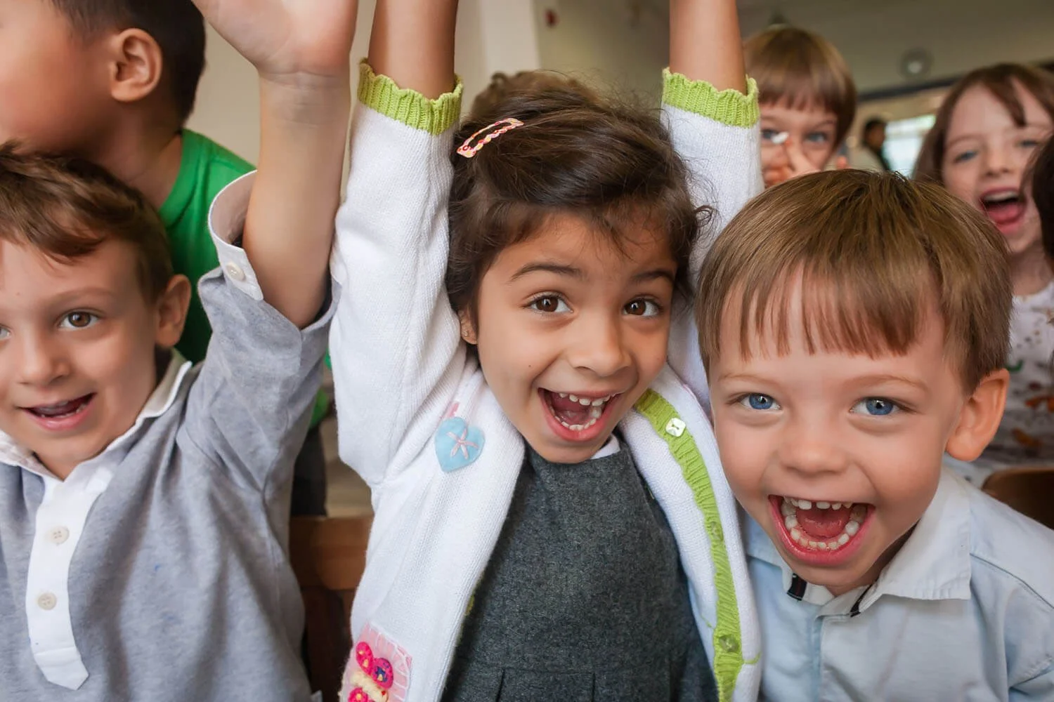 Kids cheer at the photographer in a Montessori environment in Hong Kong.