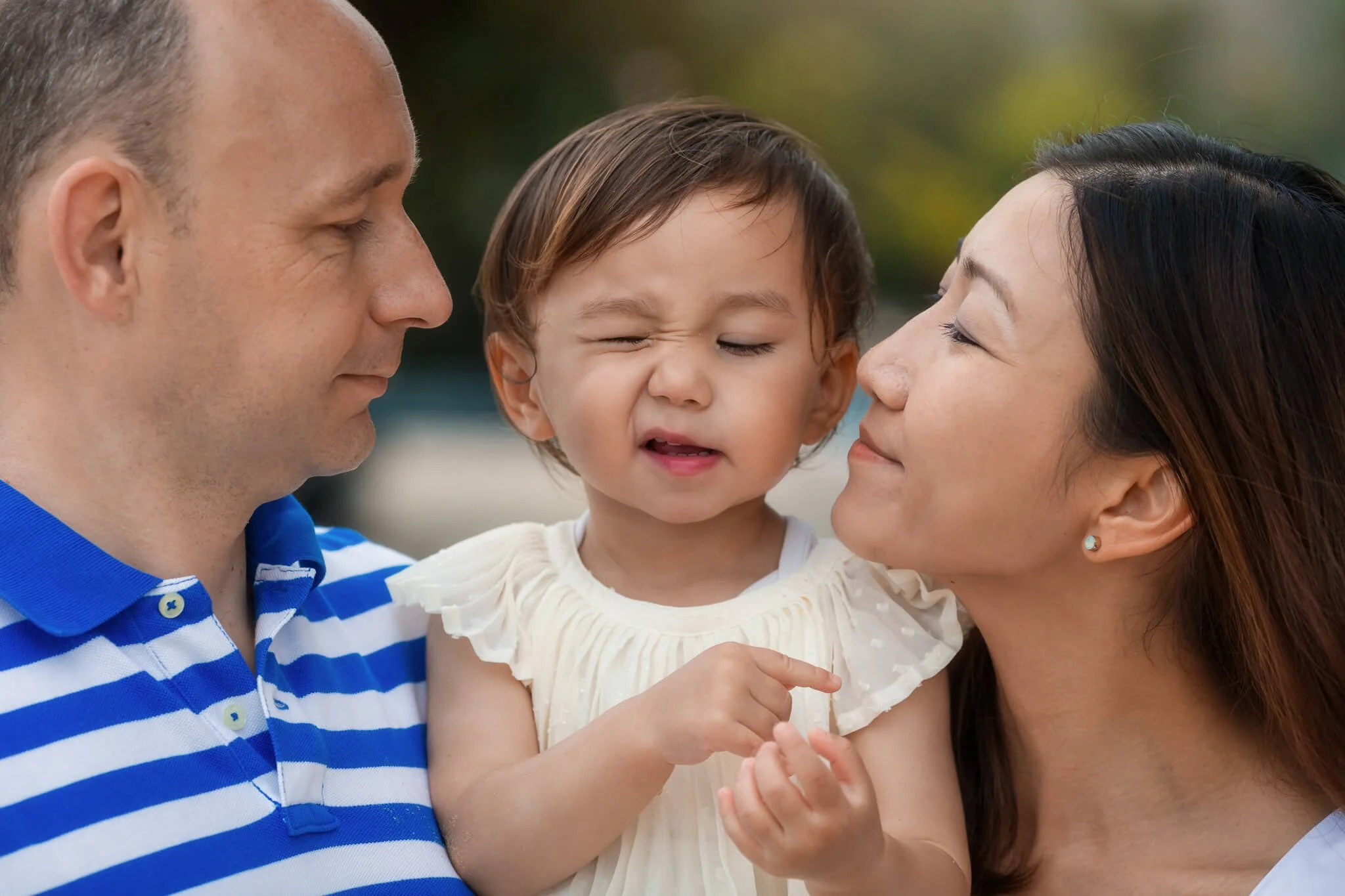 Girl making a funny face with her parents in Hong Kong