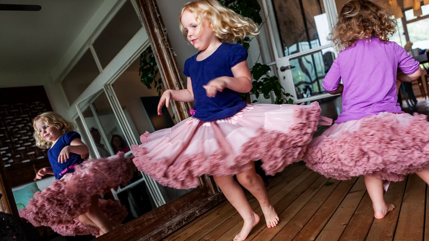 Sisters dance in the Hong Kong living room.