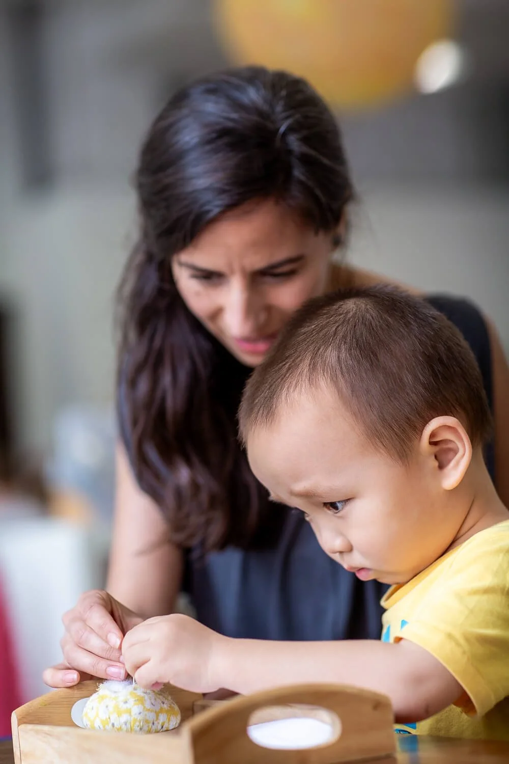 A Montessori lead teacher observing students in a Hong Kong international school; professional imagery for educational comms and differentiation.