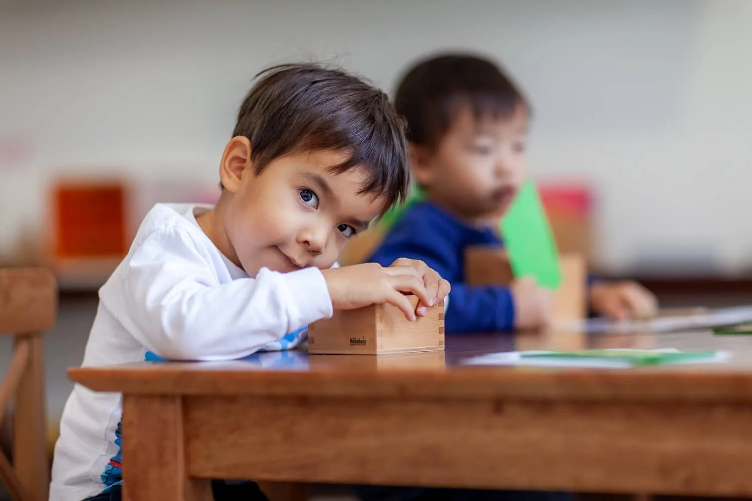 Boy plays with Montessori wooden materials at a school in HK