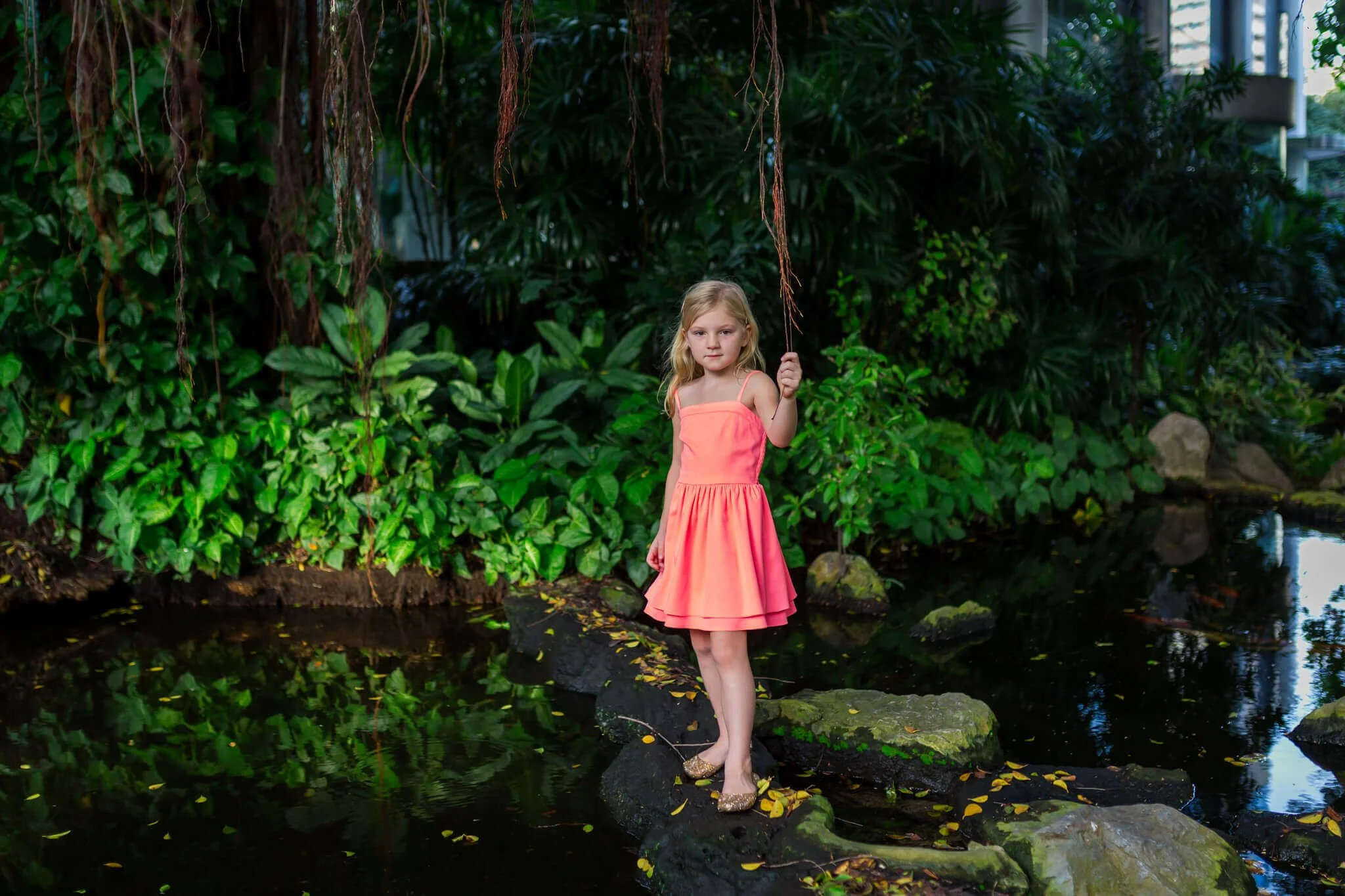 Girl standing in tropical garden