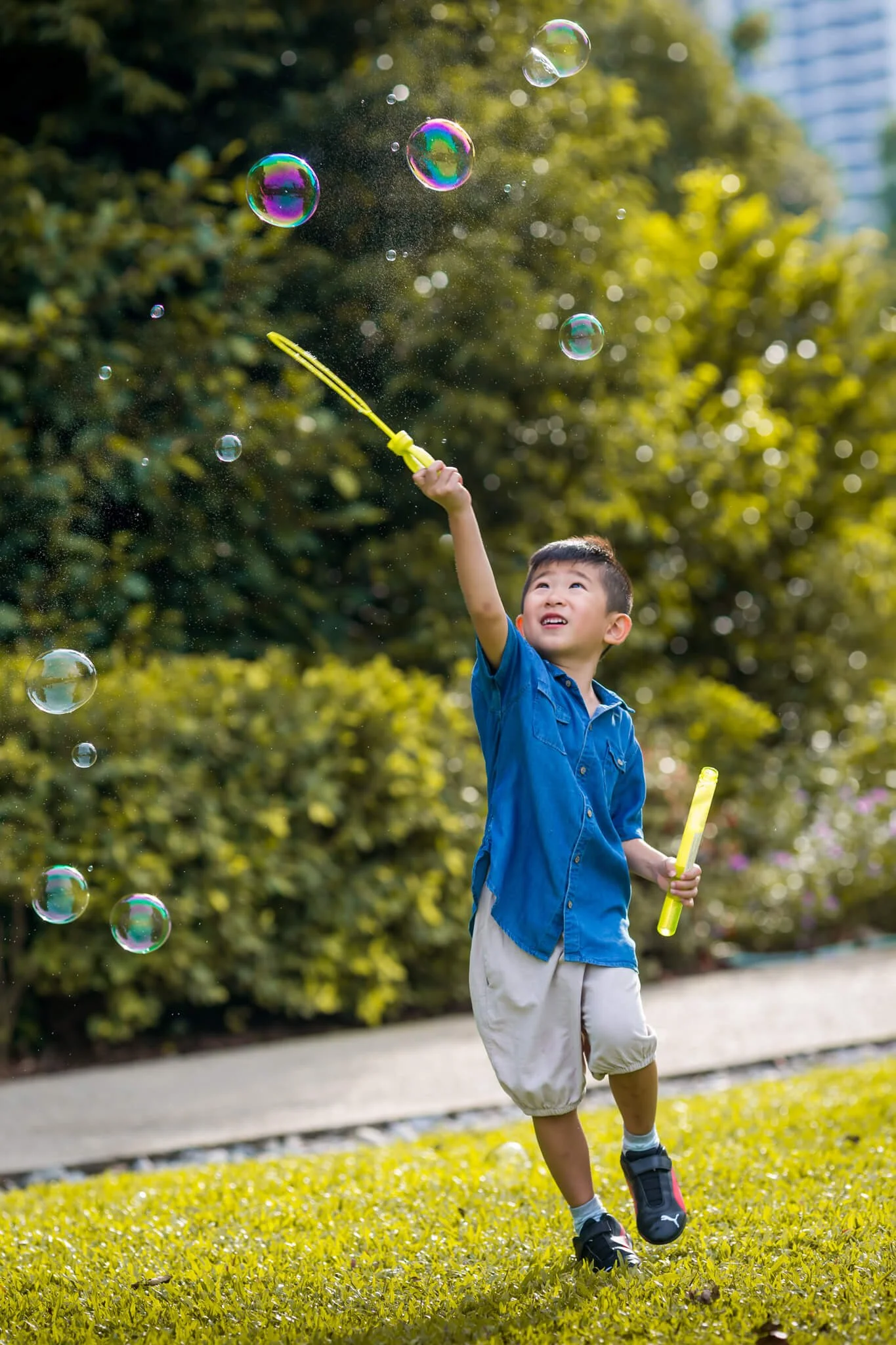 Boy playing with bubbles at the Singapore Botanical Gardens