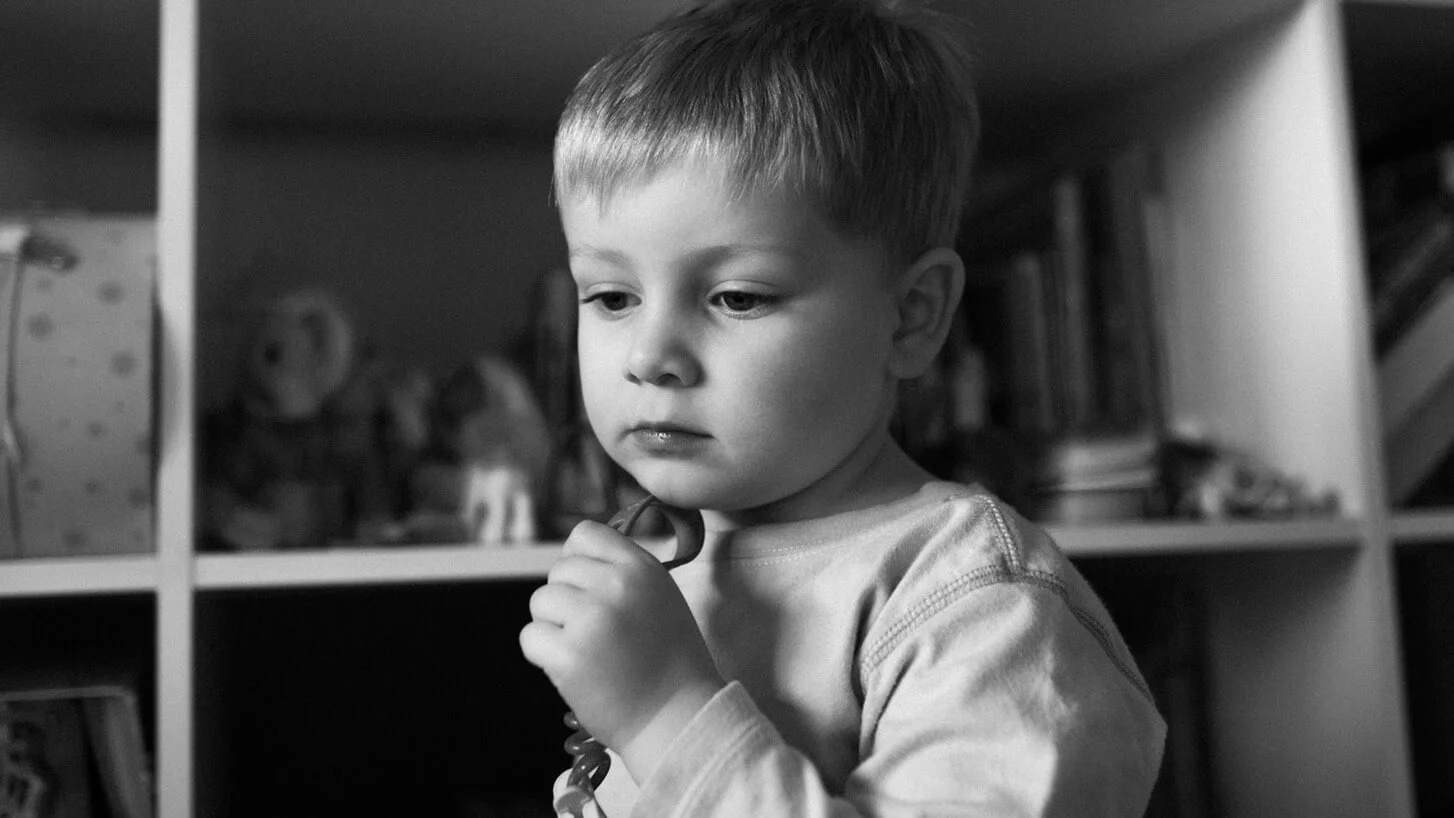 Quiet B&W portrait of a boy at home on a photoshoot, Hong Kong