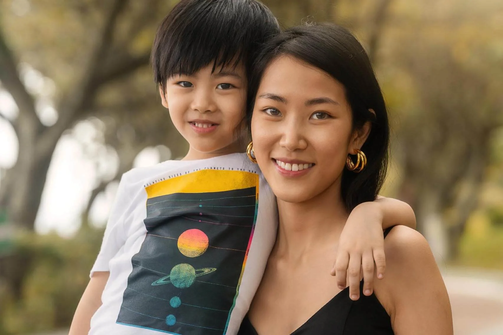 Mom and son hug in a Hong Kong park