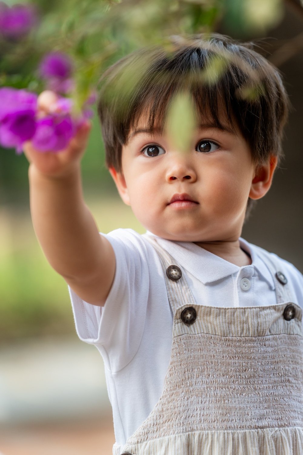 Kid plays with a flower at Lingnan Garden, Kowloon