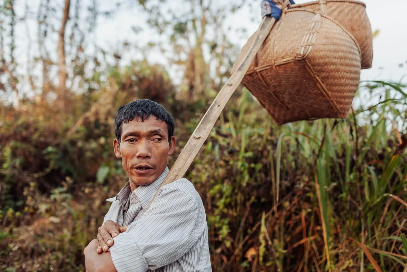 Chakma man walks between villages, Bangladesh