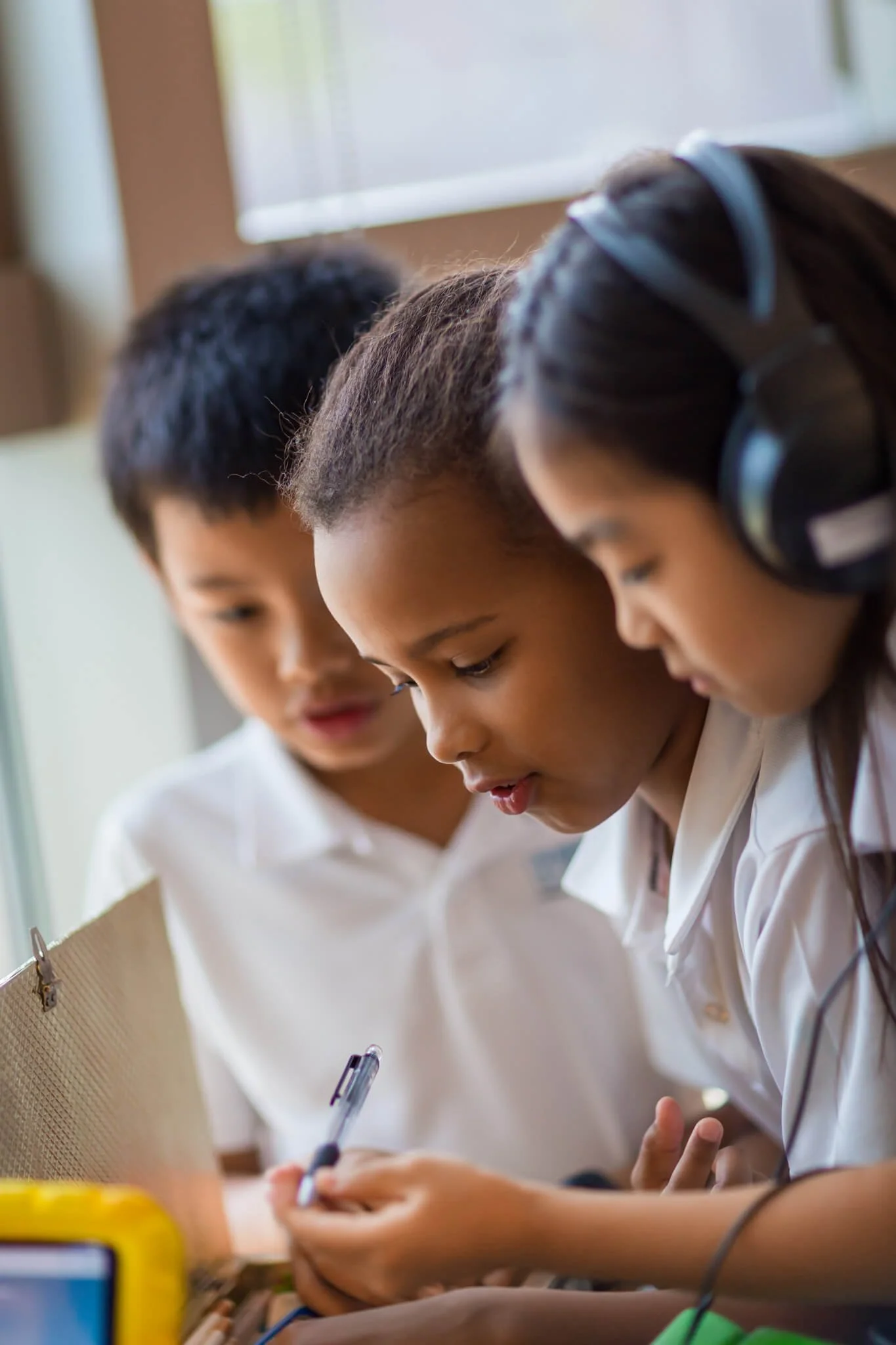 Three students work on a school project, documentary school photography by Ian Taylor

